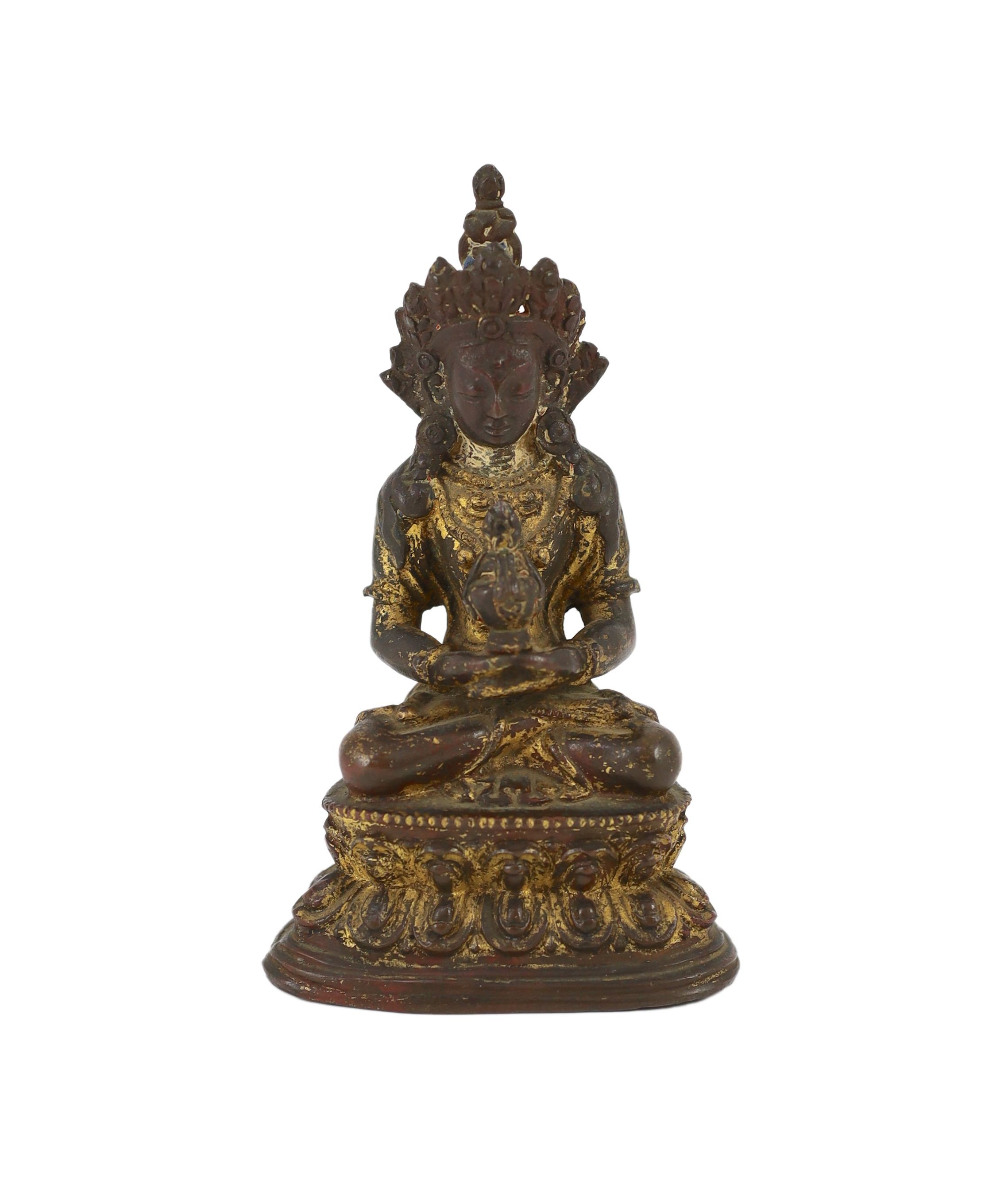 A Tibetan gilt copper alloy figure of Amitayus, 16th/17th century, 14cm high